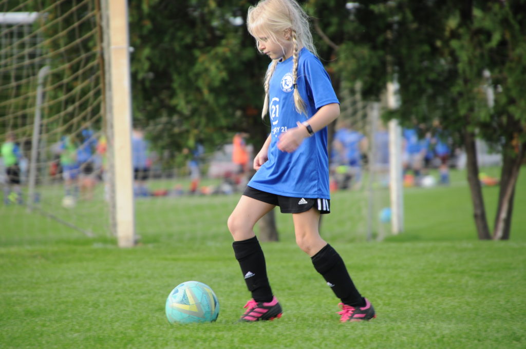 girl dribbling soccer ball