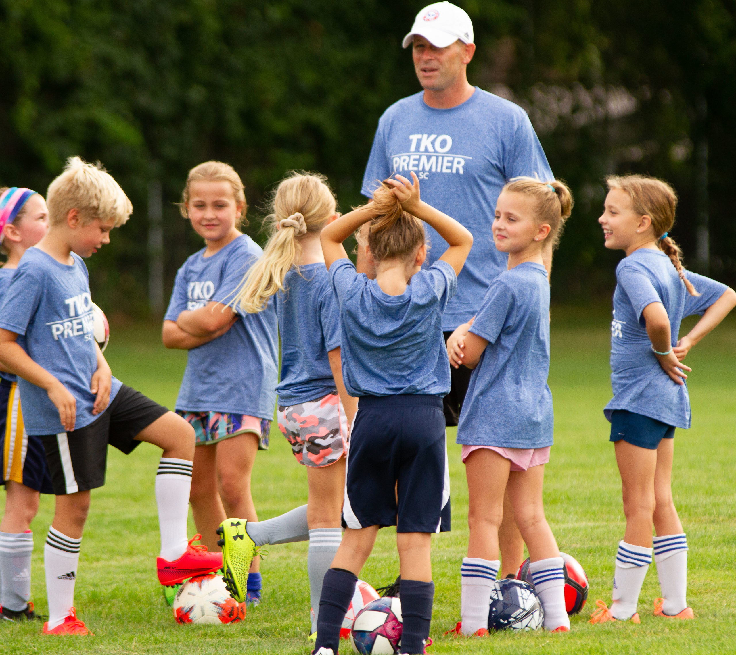 coach giving instruction to a group of players